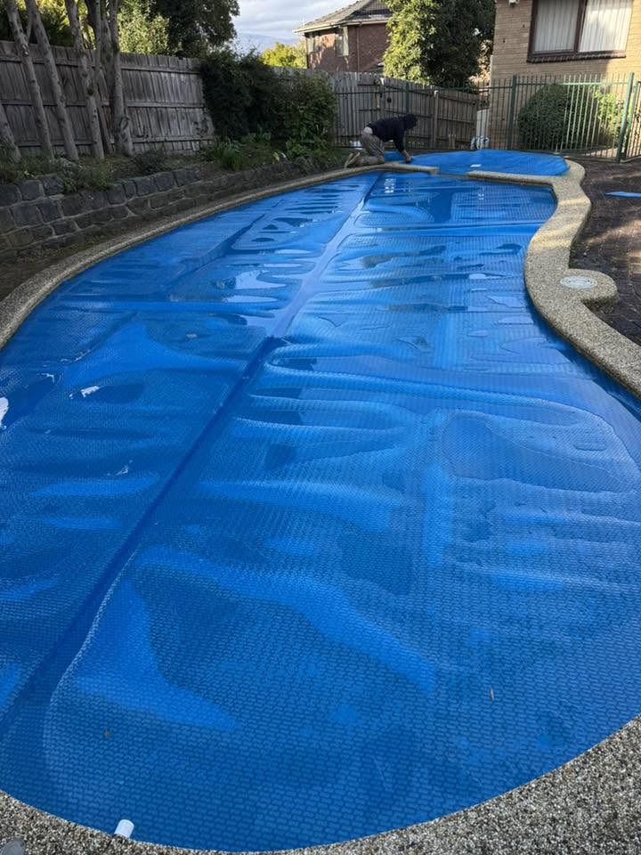 Pool blanket being installed on a Melbourne pool