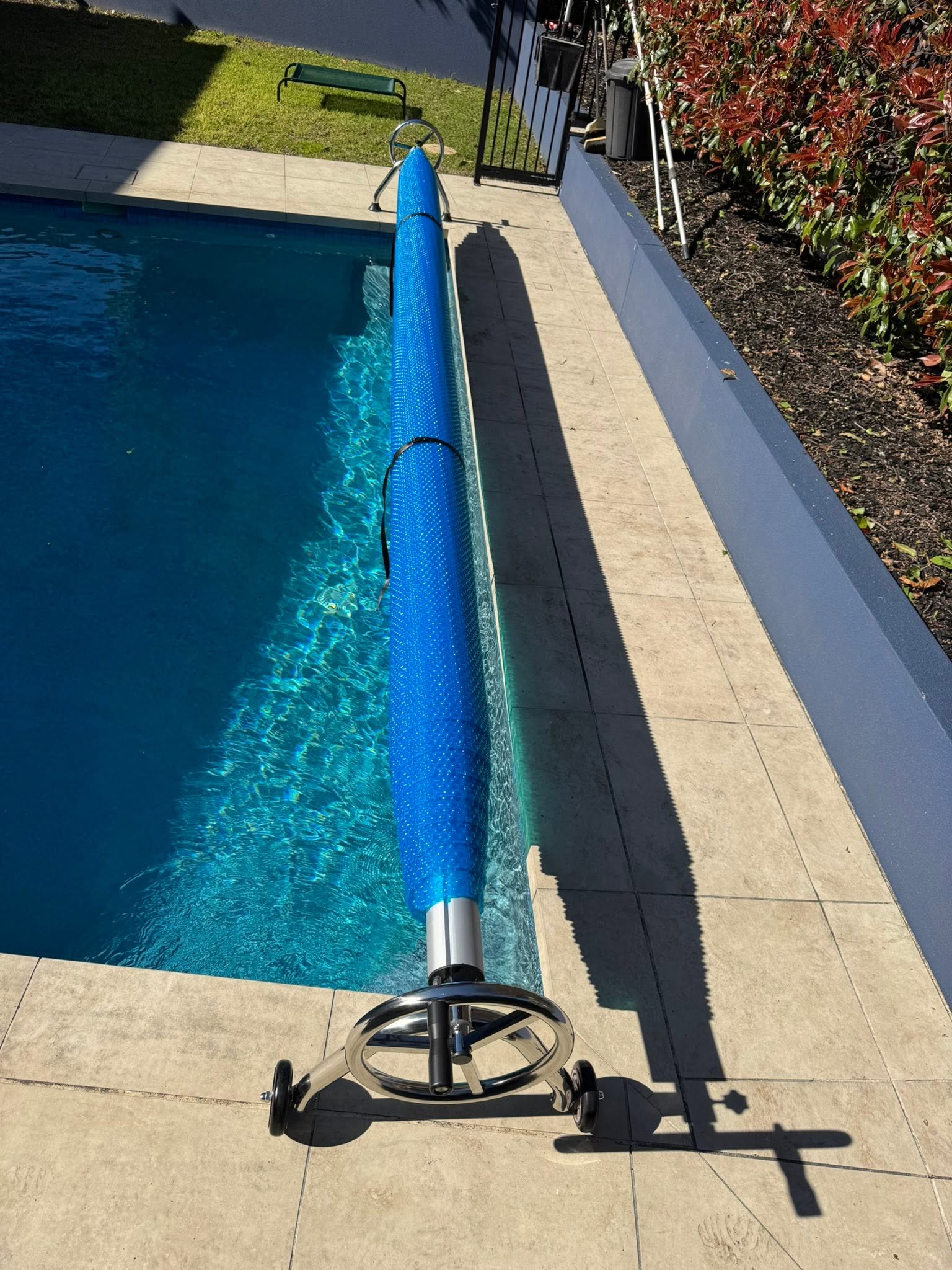Pool blanket fitted to a roller beside a Melbourne pool